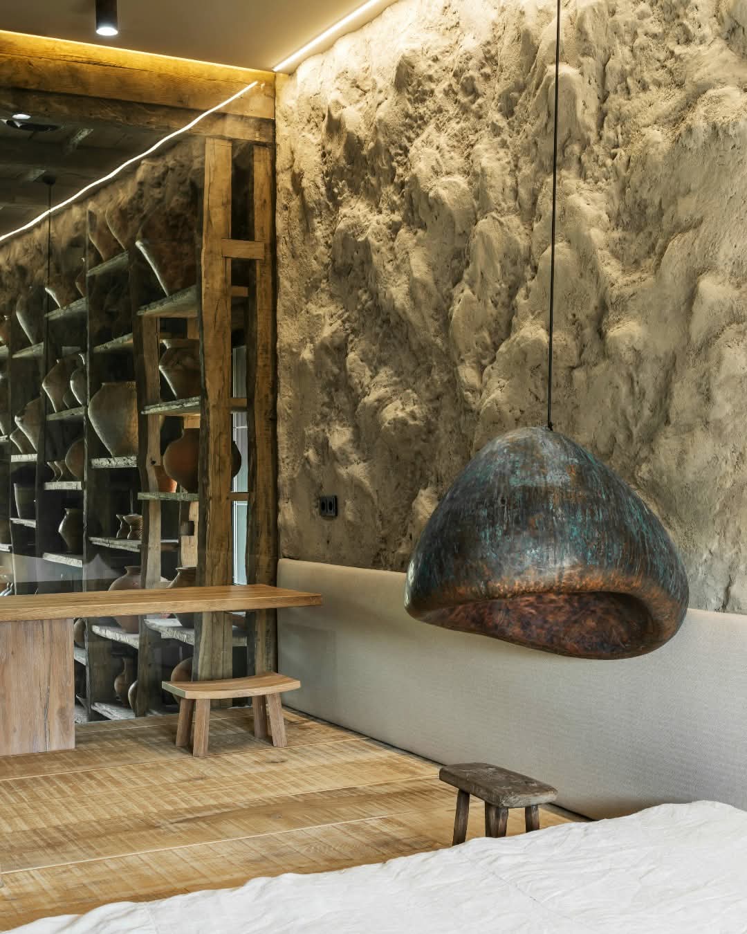 Earthy Elegance: A Rustic Bedroom with Textured Walls and Organic Accents